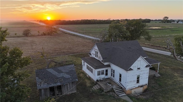 aerial view at dusk featuring a rural view