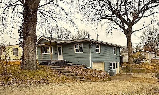 view of front of property featuring central AC and a garage