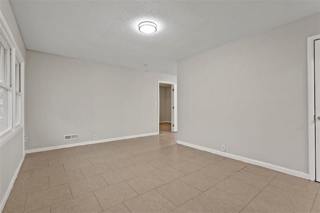 spare room featuring a textured ceiling