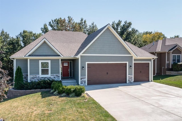 craftsman-style house with a garage and a front lawn