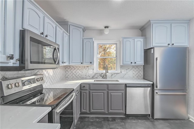 kitchen with stainless steel appliances, tasteful backsplash, and sink