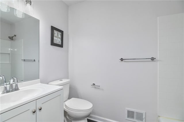 bathroom with walk in shower, vanity, and toilet