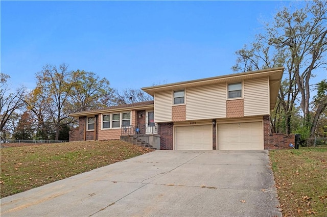 split level home featuring a front lawn and a garage