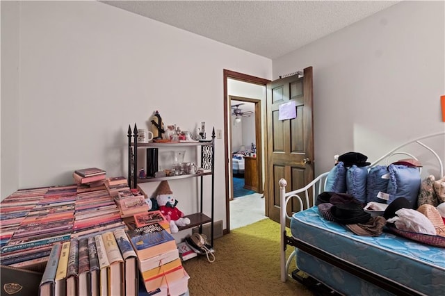 bedroom featuring carpet flooring and a textured ceiling