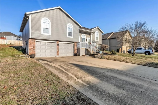 raised ranch with a garage and a front lawn