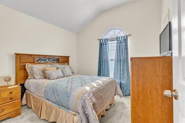 carpeted bedroom with vaulted ceiling