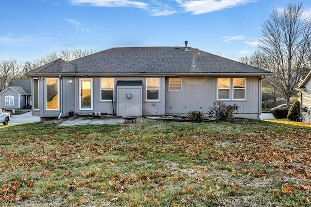 back of house featuring a patio and a lawn