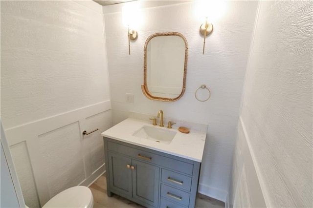 bathroom with toilet and vanity