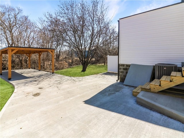 view of patio / terrace with cooling unit and driveway