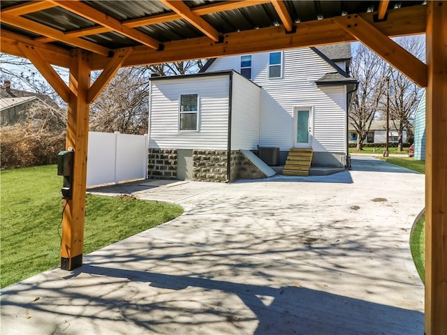 view of patio featuring entry steps and fence