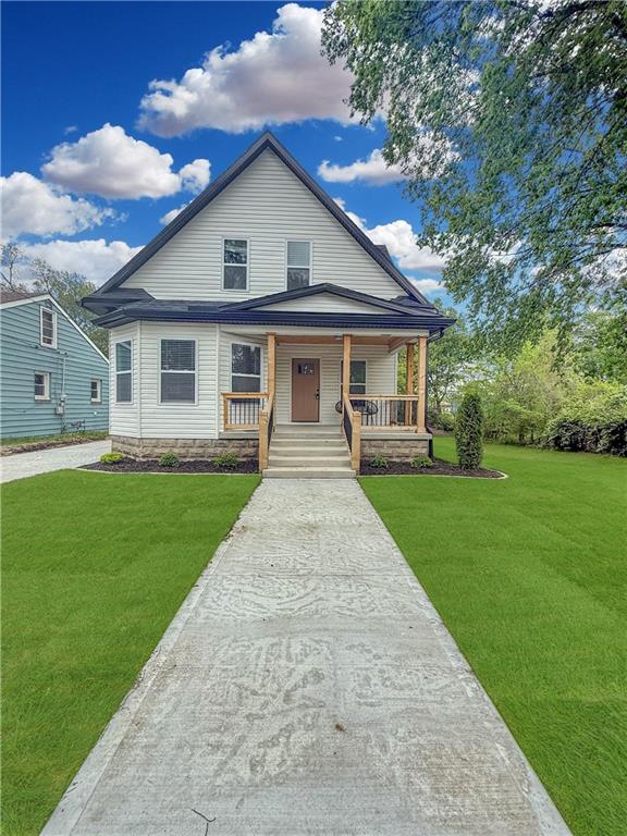 bungalow with a porch and a front yard