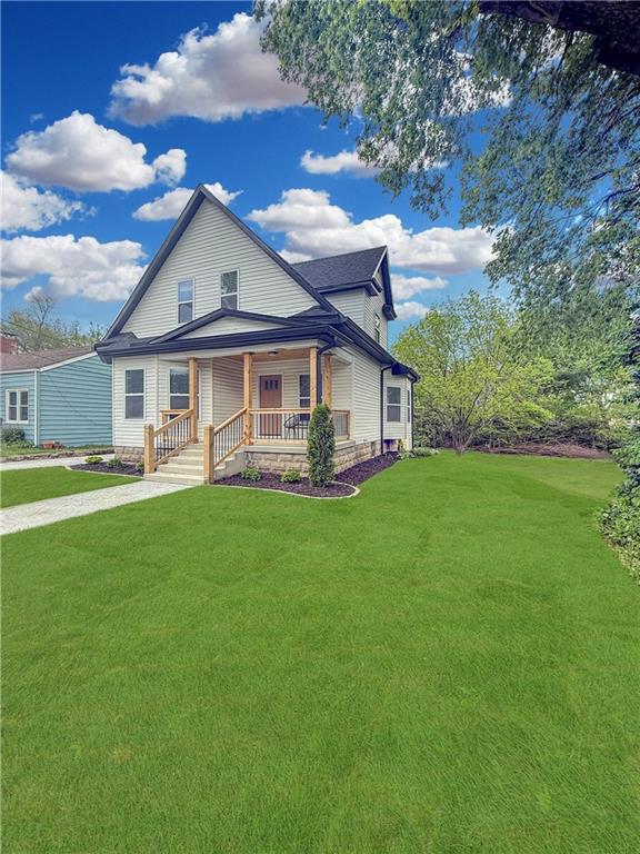 411 Charles, Warrensburg, MO 64093 - view of front of home with covered porch and a front lawn