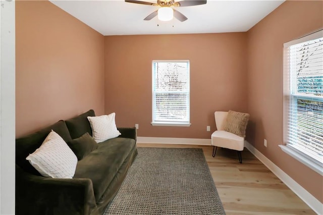 411 Charles, Warrensburg, MO 64093 - living area featuring plenty of natural light, ceiling fan, light wood-style floors, and baseboards