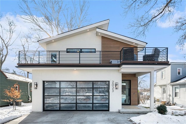 contemporary home with a balcony and a garage