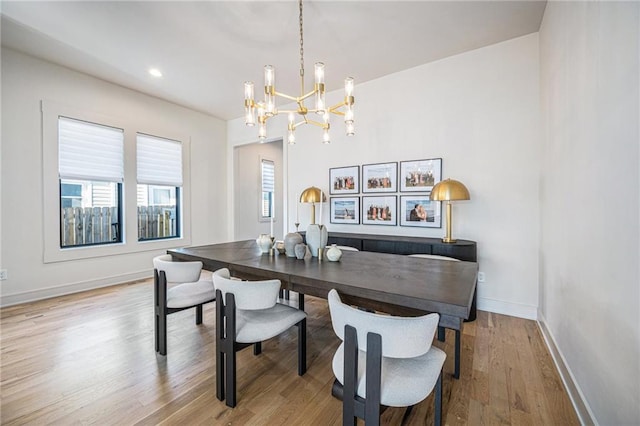 dining room with an inviting chandelier and light hardwood / wood-style floors