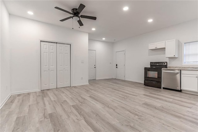 kitchen featuring stainless steel dishwasher, range with electric stovetop, light wood-type flooring, and white cabinetry