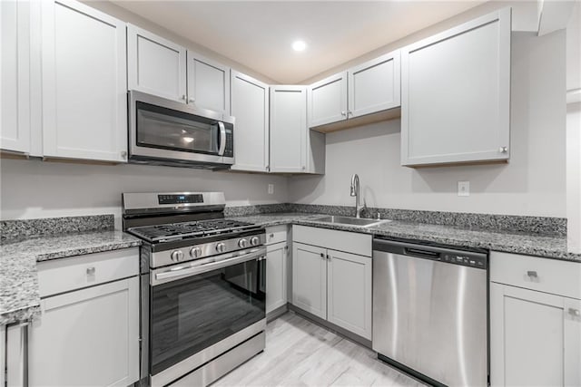 kitchen featuring white cabinetry, sink, and stainless steel appliances