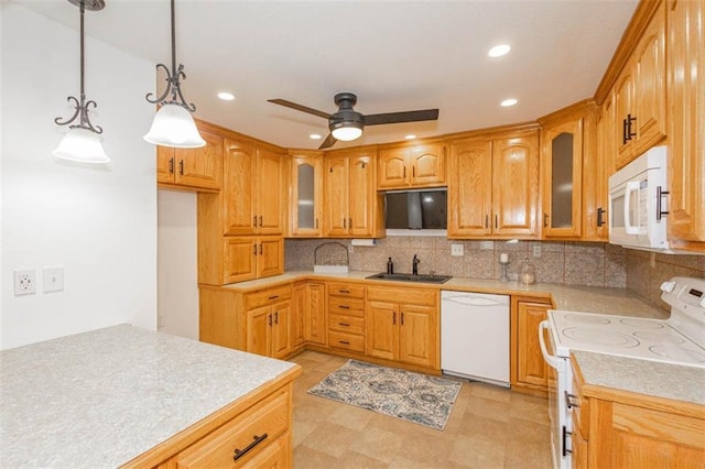 kitchen featuring tasteful backsplash, white appliances, sink, and hanging light fixtures