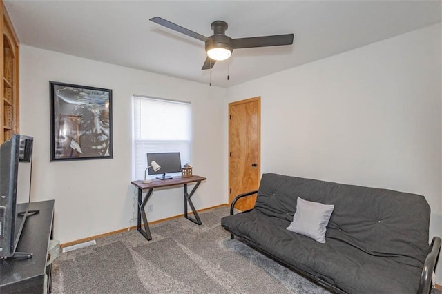 carpeted home office with ceiling fan