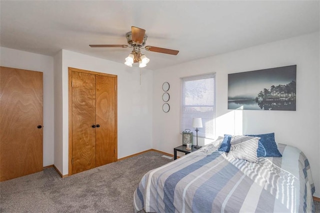 carpeted bedroom with a closet and ceiling fan