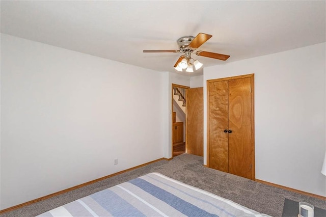 unfurnished bedroom featuring ceiling fan, carpet flooring, and a closet