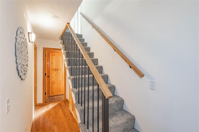 stairs with hardwood / wood-style floors