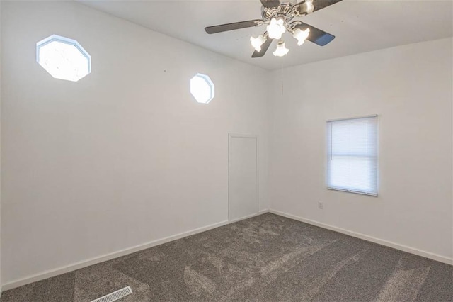 spare room with lofted ceiling, ceiling fan, and carpet flooring