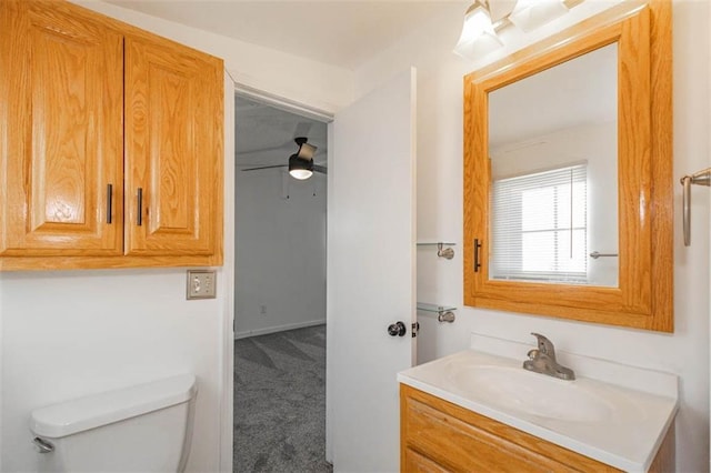 bathroom featuring vanity, ceiling fan, and toilet