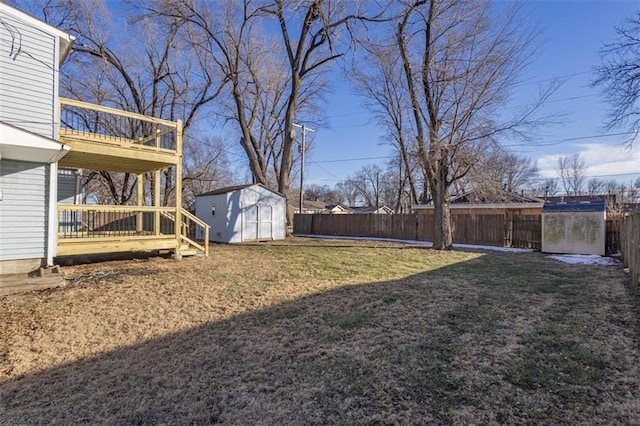 view of yard featuring a storage shed and a wooden deck