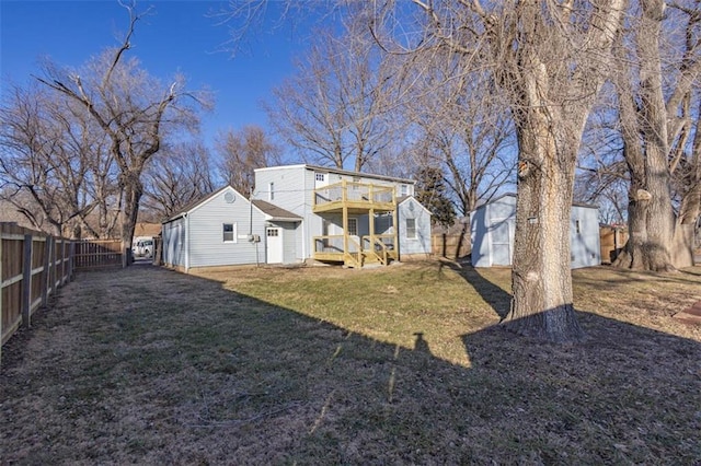 rear view of house featuring a yard and a deck