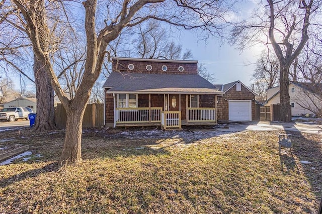 view of front facade with a garage, covered porch, and a front yard