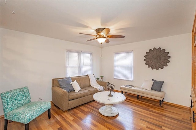 living room featuring hardwood / wood-style floors and ceiling fan