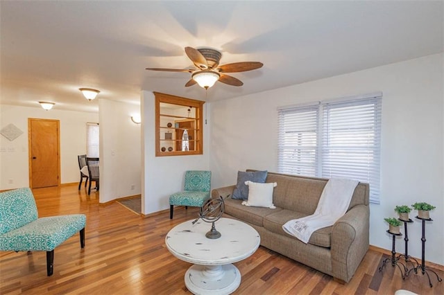 living room featuring hardwood / wood-style flooring and ceiling fan