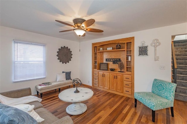 living room featuring hardwood / wood-style flooring and ceiling fan