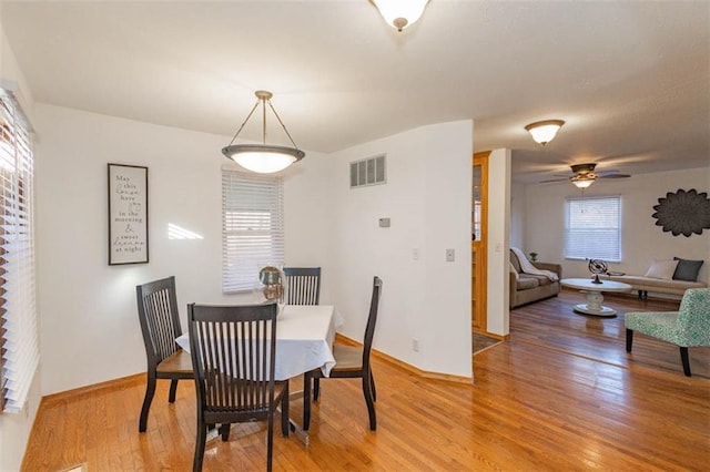 dining space featuring hardwood / wood-style floors and ceiling fan