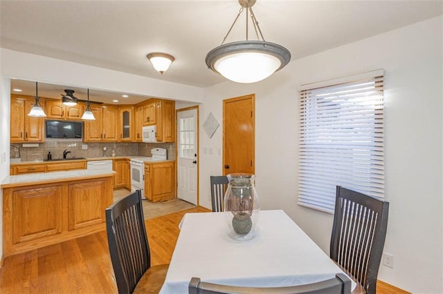 dining space featuring sink and light hardwood / wood-style floors