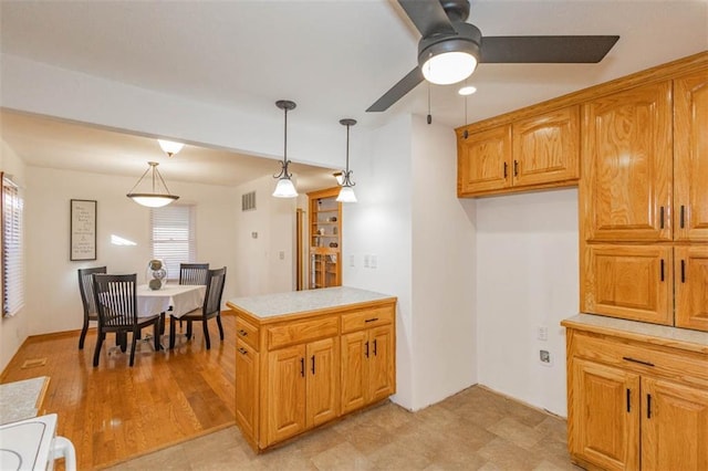 kitchen featuring stove, decorative light fixtures, and ceiling fan