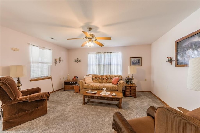 carpeted living room with ceiling fan and a healthy amount of sunlight