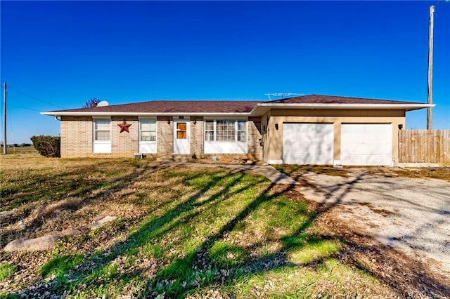 single story home featuring a garage and a front lawn