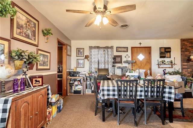 carpeted dining room featuring ceiling fan