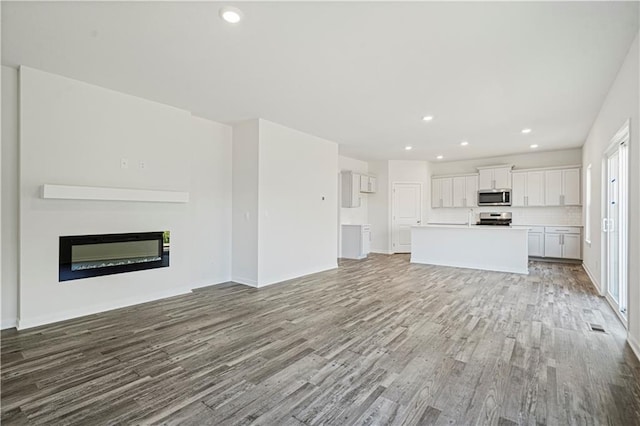 unfurnished living room with light hardwood / wood-style flooring