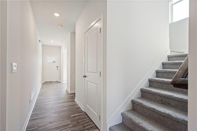 stairs featuring hardwood / wood-style floors