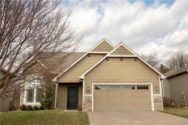 craftsman-style house with a garage and a front lawn