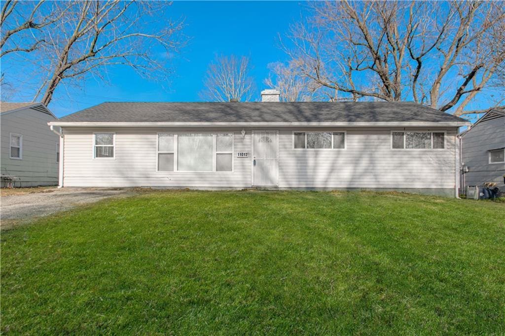 back of house with a lawn