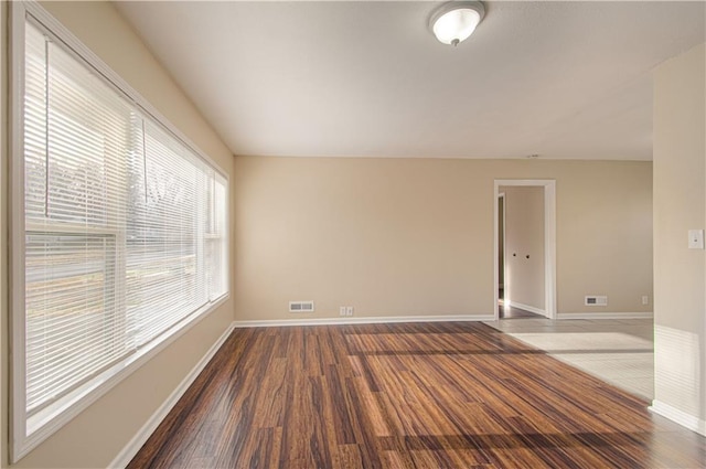 unfurnished room with wood-type flooring