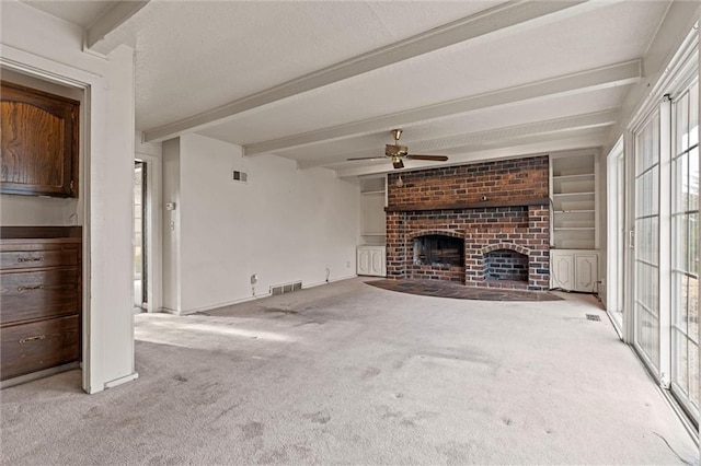 unfurnished living room with light carpet, a brick fireplace, a wealth of natural light, and beam ceiling