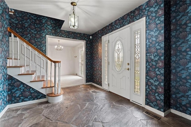 entryway with a notable chandelier