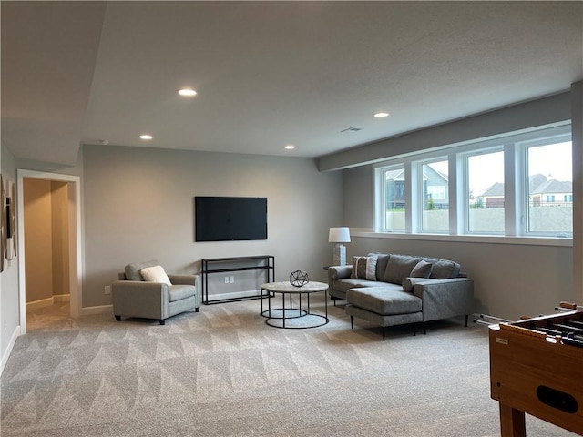 living room with recessed lighting, visible vents, light carpet, and baseboards