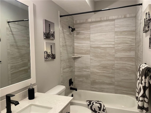 bathroom featuring toilet, shower / bath combination, and vanity
