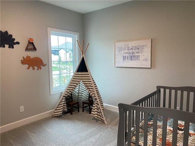 carpeted bedroom featuring baseboards